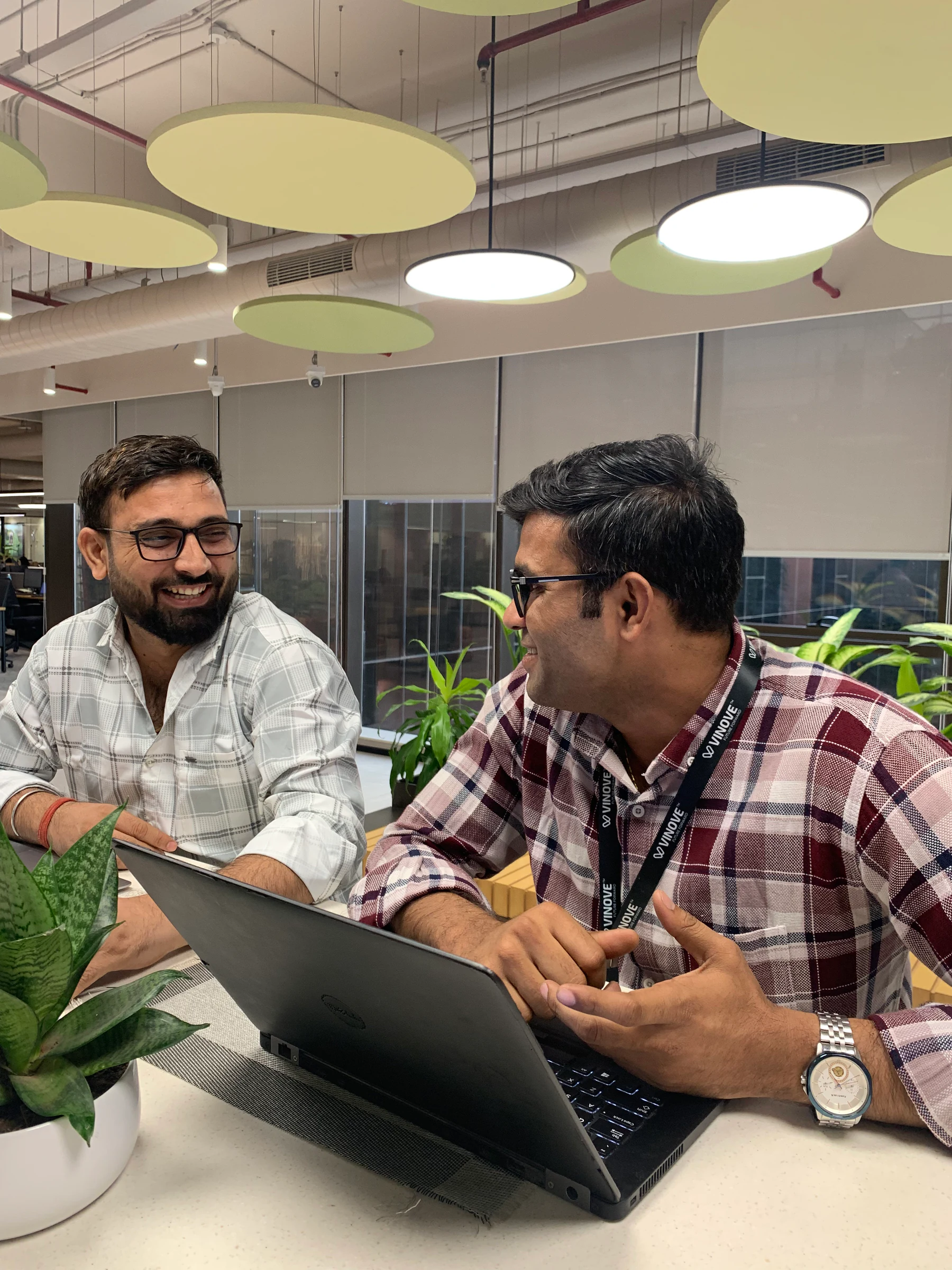 Vinove colleagues discussing work together at a laptop