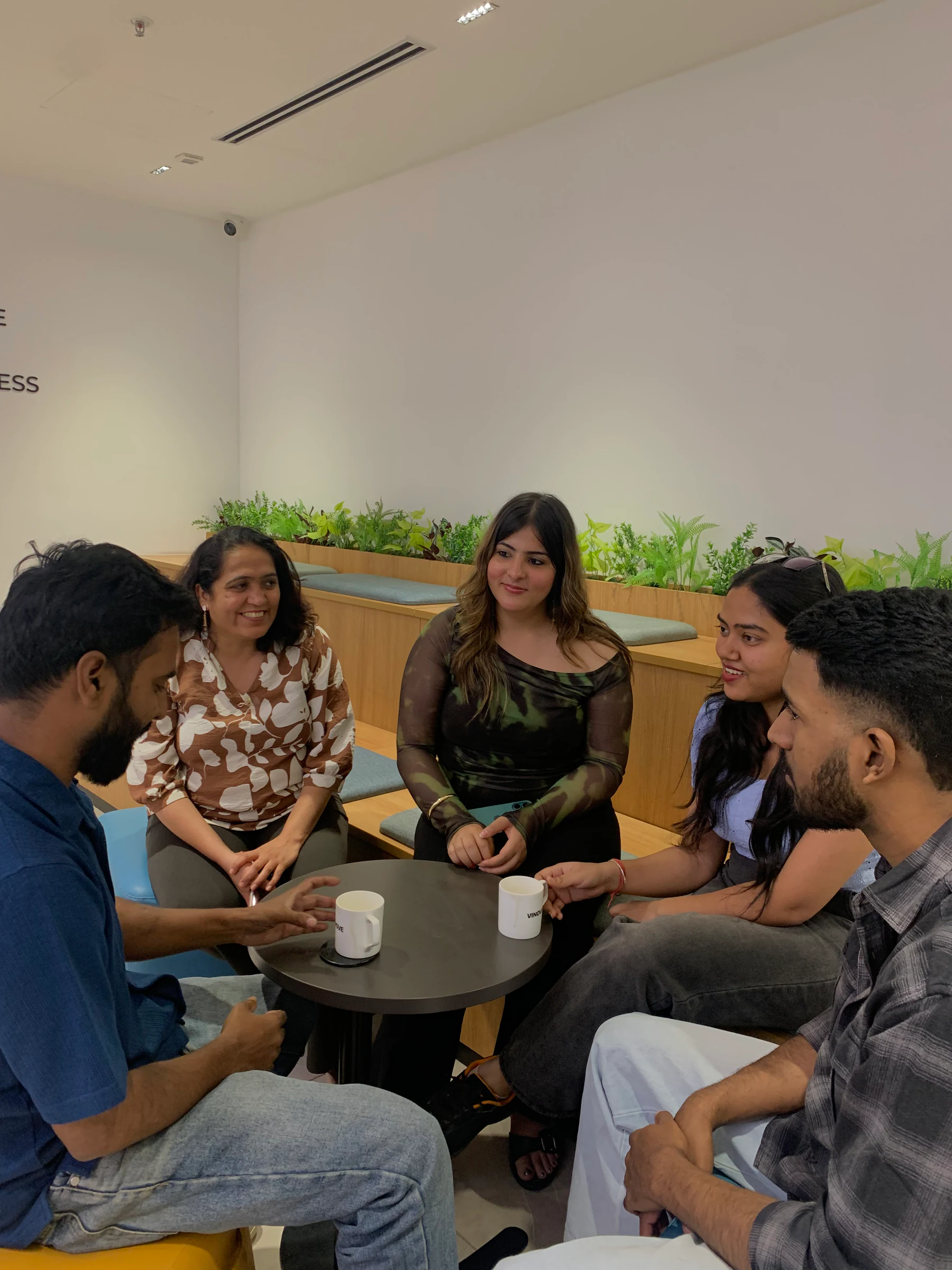 Vinove colleagues talking over coffee in the office
