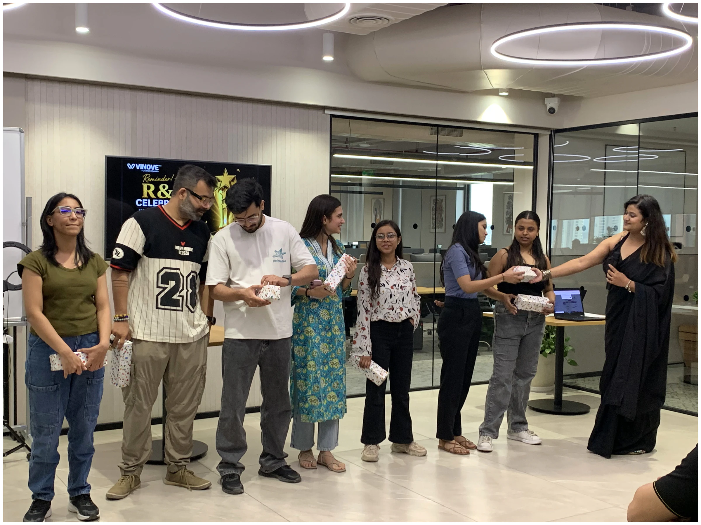 Vinove colleagues receiving recognition at an office celebration
