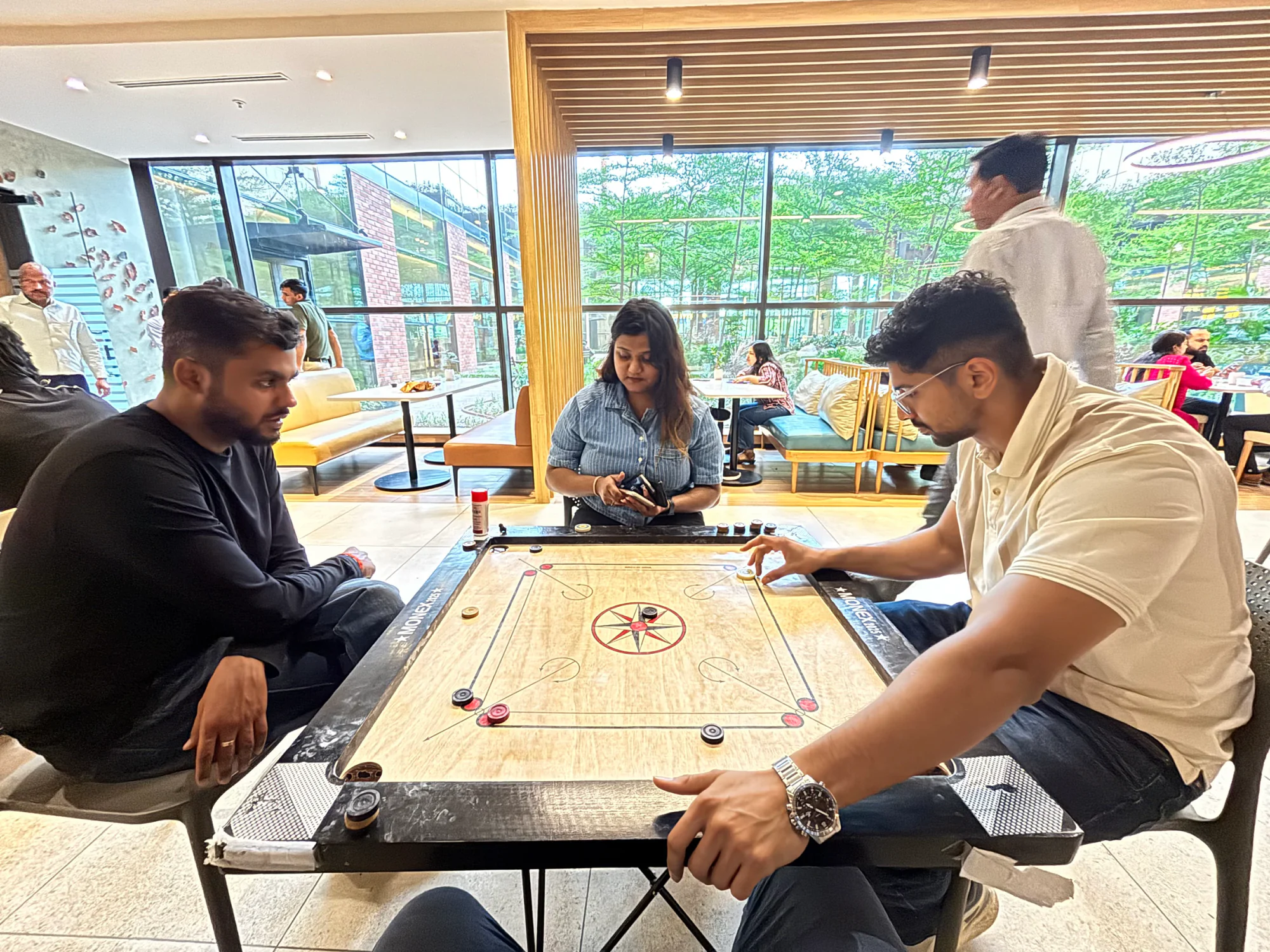 Vinove colleagues playing carrom together